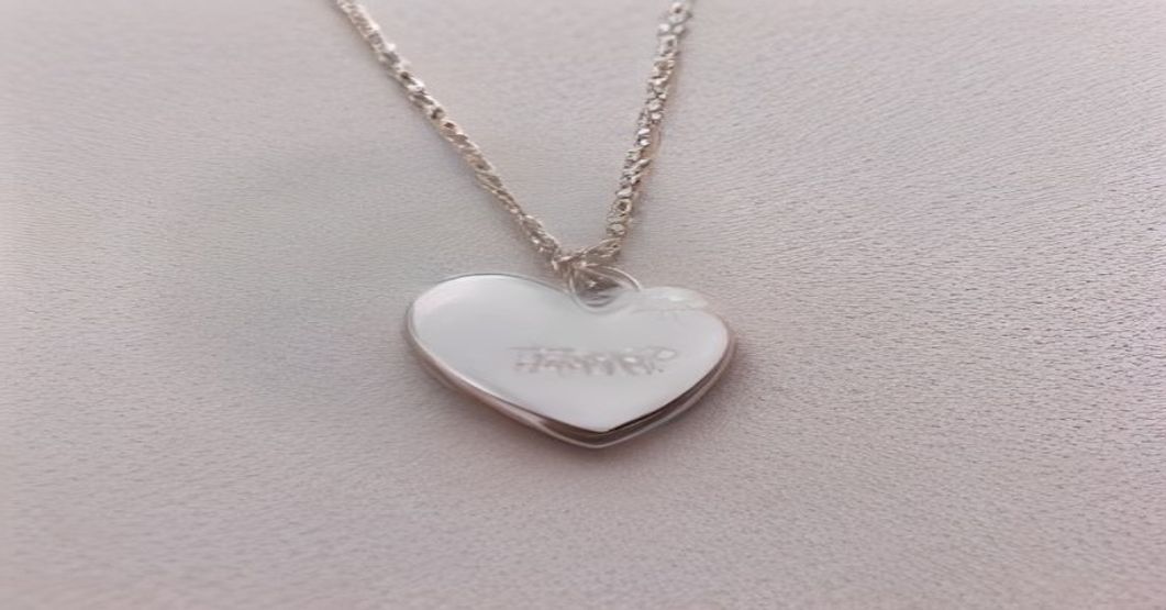Variety of custom personalized pendant necklaces in heart, oval, and star shapes with photo engravings
