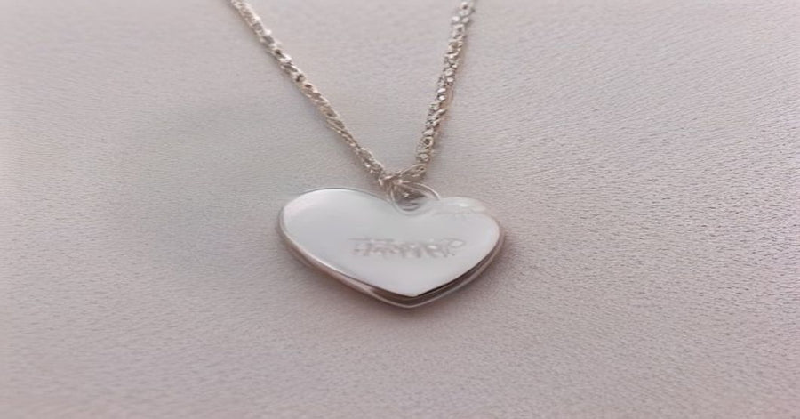 Variety of custom personalized pendant necklaces in heart, oval, and star shapes with photo engravings